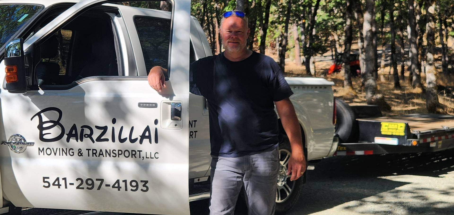 Barzillai Moving & Transport driver with truck and trailer, providing reliable transport services in Southern Oregon.